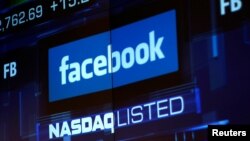 FILE - Monitors displays the Facebook, Inc. stock during morning trading at the NASDAQ Marketsite in New York, NY, U.S., June 4, 2012.