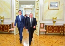 In this photo taken on Tuesday, Oct. 20, 2015, Russian President Vladimir Putin, right, and Syria President Bashar Assad arrive for their meeting in the Kremlin in Moscow, Russia.