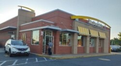 At McDonalds, some 50 million coffee cups will feature vaccine information. (Deborah Block/VOA)