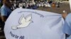 Cambodian students hold a peace banner as they celebrate the World Peace Day, in Phnom Penh, Cambodia, Friday, Sept. 21, 2012. More then one hundred of Cambodians from three religions, Buddhism, Christianity, and Islam, gathered together on Friday. (AP Photo/Heng Sinith)
