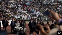 Pope Francis arrives for Mass in a golf cart at Venustiano Carranza stadium in Morelia, Mexico, Tuesday, Feb. 16, 2016.