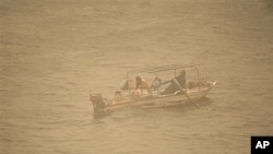 An Egyptian fisherman in his boat on the Nile river, during a dust storm in Cairo, Egypt, Dec 12, 2010
