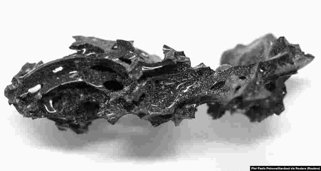 A fragment of the organic glass that was found inside the skull of the deceased individual, who was killed in the eruption of Mount Vesuvius in 79 AD, at the archaeological site of Herculaneum in Italy. February 27, 2025