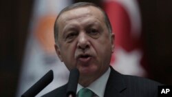 FILE - Turkey's President and leader of ruling Justice and Development Party Recep Tayyip Erdogan addresses the members of his ruling party at the parliament in Ankara, Turkey, Feb. 13, 2018.
