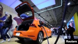 FILE - A Volkswagen E-Golf electric vehicle is seen at the Canadian International Auto Show in Toronto, Canada, Feb. 18, 2020.