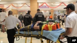 An unidentified injured person is carried to an ambulance in Granbury, Texas, May 15, 2013.