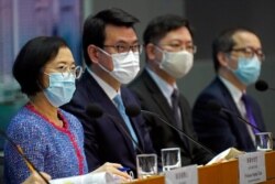 Secretary for Food and Health Sophia Chan and other officials attend a press conference in Hong Kong, Nov. 11, 2020. Hong Kong and Singapore will at month's end allow travelers in both cities to visit the other without having to serve quarantine.