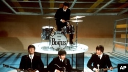 FILE - In this Feb. 9, 1964 file photo, The Beatles perform on the CBS "Ed Sullivan Show" in New York. An acetate record cut by the Beatles before the Liverpool band hit stardom is going on auction.