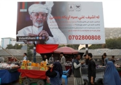 FILE - A billboard depicting Afghanistan's presidential candidate Ashraf Ghani is displayed in Kabul, Afghanistan, Sept. 25, 2019.