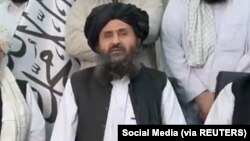Mullah Baradar Akhund, a senior official of the Taliban, seated with a group of men, makes a video statement, in this still image taken from a video recorded in an unidentified location and released on August 16, 2021. Social Media/via REUTERS THIS IMAGE HAS BEEN SUPPLIED BY A 