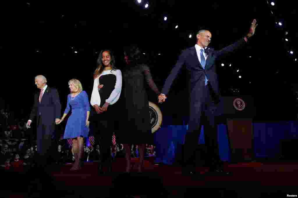 President Barack Obama (R) is joined onstage by first lady Michelle Obama and daughter Malia, Vice President Joe Biden and his wife Jill Biden, after his farewell address in Chicago, Illinois, Jan. 10, 2017. 