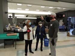 After recovering from COVID-19, Chris Porr (right) spends time volunteering to deliver food packages to those in need. (Photo by New York Cares)