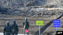 South Korean soldiers stand at Arrowhead Ridge, a site of battles in the 1950-53 Korean War, as a tactical road is built across the military demarcation line inside the Demilitarized Zone (DMZ) at Cheorwon, Gangwon Province, in South Korea, Nov. 22, 2018.