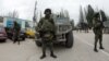 Unidentified armed individuals with armored vehicles block base of Ukrainian border guard service, Sevastopol, March 1, 2014.