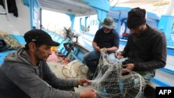 Tunisian fishermen prepare their nets in Zarzis, Tunisia, May 21, 2019. Tunisian fishermen are more involved in rescuing migrants because of the difficulties of NGOs in the Mediterranean and the disengagement of European military ships.