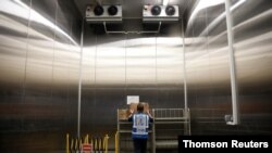 온도 조절이 가능한 싱가포르 디나타사의 냉동 저장소에서 직원이 신종 코로나바이러스 백신이 담긴 상자를 옮길 준비를 하고 있다. (자료사진)