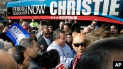 New Jersey Gov. Chris Christie, center, greets supporters during a campaign stop in Hillside, Nov. 4, 2013. Christie will face Democratic candidate, Barbara Buono in the election on Tuesday.