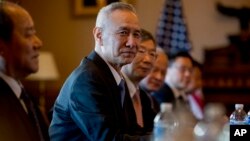 FILE - Chinese Vice Premier Liu He, center, accompanied by other Chinese officials, begins talks with U.S. Trade Representative Robert Lighthizer at the Executive Office Building on the White House Complex, Jan. 30, 2019.