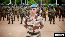 FILE - U.N. peacekeepers mark the start of the 12,000-strong U.N. peacekeeping mission, called MINUSMA, in Mali, July 1, 2013. Another 2,500 peacekeeping troops will be sent to Mali in light of recent violence.