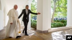 President Barack Obama and Pope Francis walk down the Colonnade before meeting in the Oval Office of the White House, Sept. 23, 2015. 