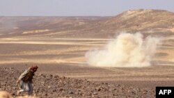 FILE - Smoke billows during clashes between forces loyal to Yemen's Saudi-backed government and Houthi rebel fighters in al-Jadaan area, northwest of Marib, central Yemen, Feb. 11, 2021.