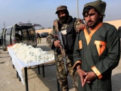 FILE - A captured Taliban insurgent is presented to the media after he was detained with car explosive devices in Jalalabad, Afghanistan, Dec. 10, 2019.