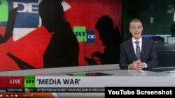 A presenter for the Russian state broadcaster RT delivers a report on YouTube's shutting down two of RT's German channels over alleged coronavirus misinformation in this screengrab from YouTube.