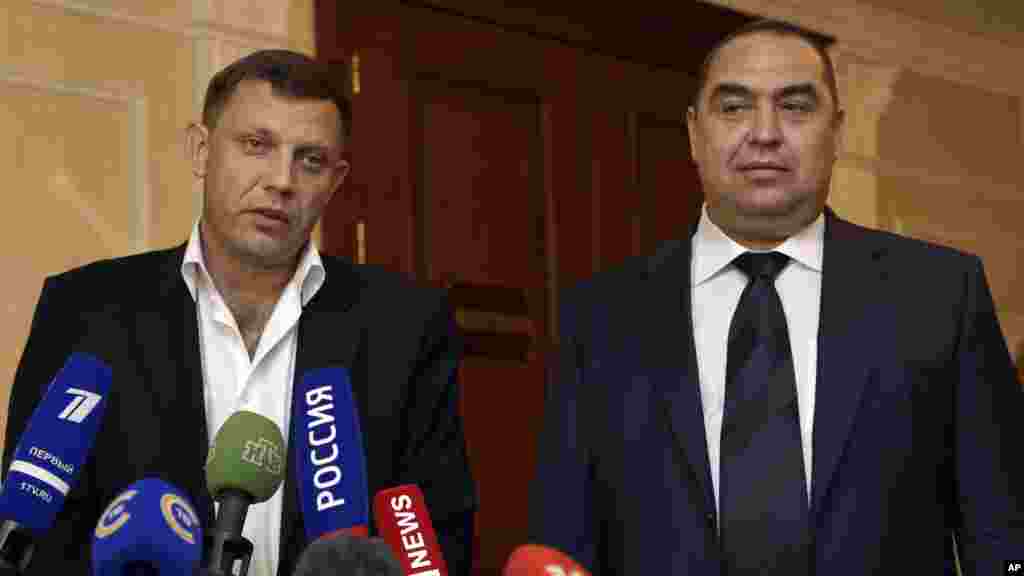 From left, Alexander Zakharchenko, the leader of pro-Russian rebels in Donetsk, and Igor Plotnitsky, the leader of pro-Russian rebels in the Luhansk region, meet with the media after peace talks in Ukraine in Minsk, Belarus, early Saturday, Sept. 20, 2014
