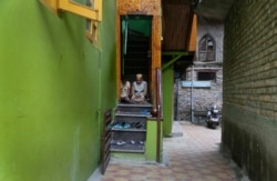 Kashmiri Muslim boys offer Friday prayers at the doorway of a local mosque in an alley during curfew like restrictions in Srinagar, India, Aug. 16, 2019.