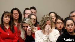 Victims and others look on as Rachael Denhollander speaks at the sentencing hearing for Larry Nassar, a former team USA Gymnastics doctor who pleaded guilty in November 2017 to sexual assault charges, in Lansing, Michigan, Jan. 24, 2018.