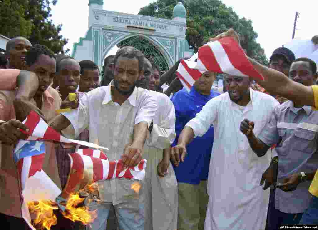 A group of Kenyan muslims burn the U.S. flag following afternoon prayers outside the Sakina Jamia Mosque in the port city of Mombasa, Sept. 14, 2012.