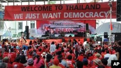 Red Shirt protesters listen to a speaker at the Ratchaprasong intersection during an ongoing rally in central Bangkok, 20 Apr 2010