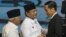 Indonesian presidential candidates Joko Widodo, right, Prabowo Subianto, center, and Subianto's running mate Hatta Rajasa greet each other during a televised debate in Jakarta, June 9, 2014