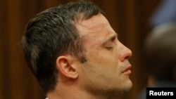 Olympic and Paralympic track star Oscar Pistorius reacts as he listens to Judge Thokozile Masipa's judgement at the North Gauteng High Court in Pretoria, September 11, 2014. A South African judge cleared Oscar Pistorius of all murder charges on Thursday, 
