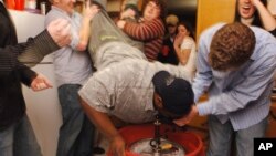 FILE - A student does a "keg-stand" over a keg of beer in Columbia, Mo., Nov. 12, 2005.