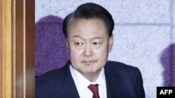 (FILES) South Korea's impeached President Yoon Suk Yeol arrives to attend the fourth hearing of his impeachment trial over his short-lived imposition of martial law at the Constitutional Court in Seoul on January 23, 2025.