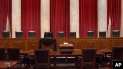 This photo provided by the Collection of the Supreme Court of the United States shows the Courtroom of the Supreme Court showing Associate Justice Antonin Scalia’s Bench Chair draped in black, Tuesday, Feb. 16, 2016, at the court in Washington. (Franz Jantzen/Collection of the Supreme Court of the United States via AP)