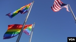 A woman is taken by ambulance as police officers investigate a scene following reports of a stabbing in Sydney, Australia.