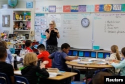 Upper multi-aged teacher of grades 4 to 6 at Orangethorpe Elementary School, Pamela Keller, teaches students cursive writing at Orangethorpe Elementary School, in Fullerton, California, U.S. January 23, 2024. (REUTERS/Mike Blake)