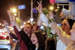 People react during an opposition rally to protest against police violence and to reject the presidential election results in Minsk, Belarus, Aug. 13, 2020.