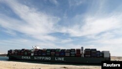 FILE - A container ship of China Shipping Line sails through the Suez Canal in Ismailia, Egypt, Nov. 17, 2019.