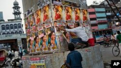 A Bangladeshi man glues movie posters in Dhaka, Bangladesh, Nov. 5, 2015. Fear is running high following months in which four bloggers and three other people have been killed. 