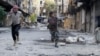 FILE - Mohammad (R), a 13 year-old fighter from the Free Syrian Army, aims his weapon as he runs from snipers loyal to the Syrian regime in Aleppo's Bustan al-Basha district October 29, 2013.