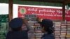 FILE - Myanmar police officers inspect seized drugs during a destruction ceremony of seized narcotic drugs on the outskirts of Yangon, Myanmar, Monday, June 26, 2017. 