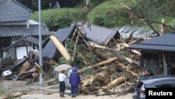 Local residents look at a landslide site caused by Tropical Storm Lan in Ayabe, Kyoto prefecture, western Japan Aug. 15, 2023, in this photo taken by Kyodo. (Kyodo via Reuters) 