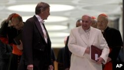Pope Francis leaves at the end of the afternoon session of an extraordinary consistory in the Synod hall at the Vatican City, Feb. 20, 2014.
