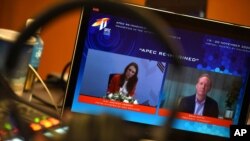 This photo released by Malaysia Department of Information shows New Zealand's Prime Minister Jacinda Ardern and Microsoft President Brad Smith at a virtual meeting during the APEC CEO Dialogues 2020 on Nov. 20, 2020.