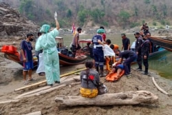 An injured Myanmar refugee is transported to a hospital in Mae Sam Lap, Thailand, after crossing the Salween river while fleeing from airstrikes in Myanmar's eastern Karen state following the military coup. (Credit: Royal Thai Army)