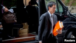 Representatives from Alibaba Group Holding arrive for the company's roadshow meeting in New York, Sept. 8, 2014. 