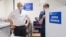 FILE - British Prime Minister Boris Johnson watches as a dose of the AstraZeneca COVID-19 vaccine is prepared by a nurse, at a coronavirus vaccination site in north London, Britain, Jan. 25, 2021.